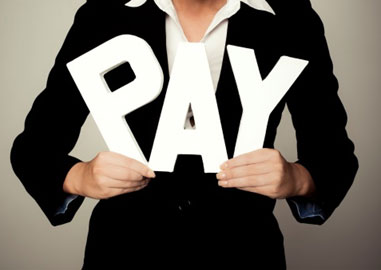 Woman holding "Pay" sign
