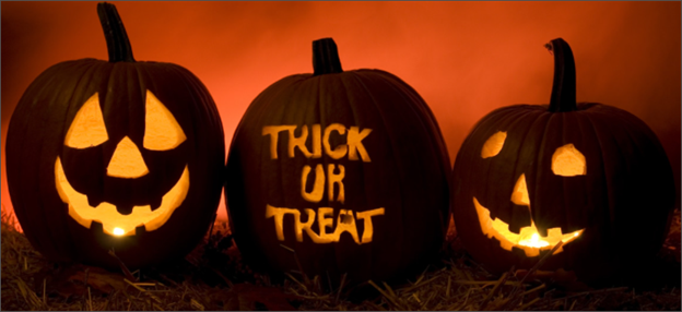 Three carved Halloween jack-o-lanterns sitting in a row, on a smoky-orange background, the middle pumpkin says "Trick or Treat"