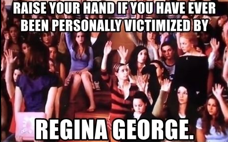 A still from the movie "Mean Girls" of a group of students with their hands raised, with white overlaying text that reads "raise your hand if you have ever been personally victimized by Regina George"