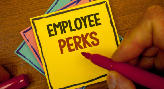 A yellow sticky note with the words "Employee Perks" written in marker