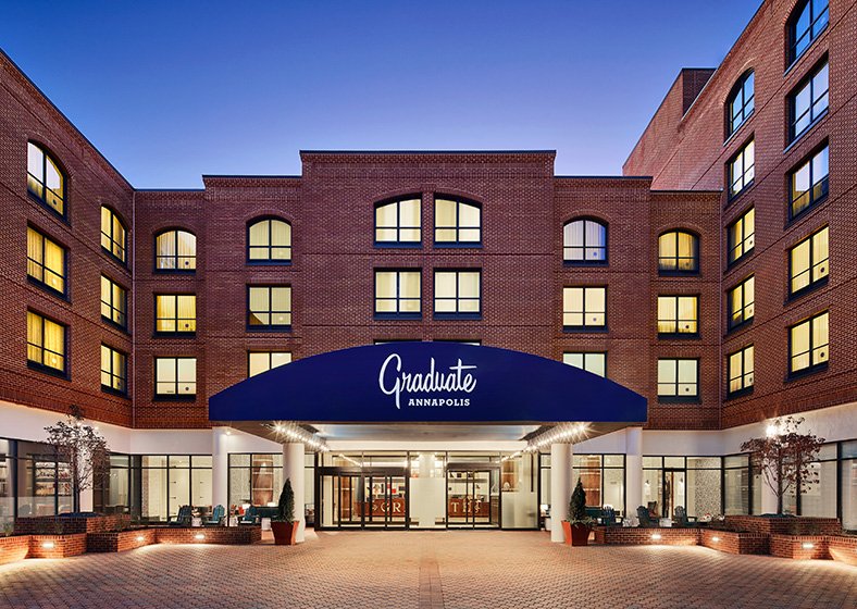 Exterior of the conference hotel, photographed in the early evening hours with a long blue awing.