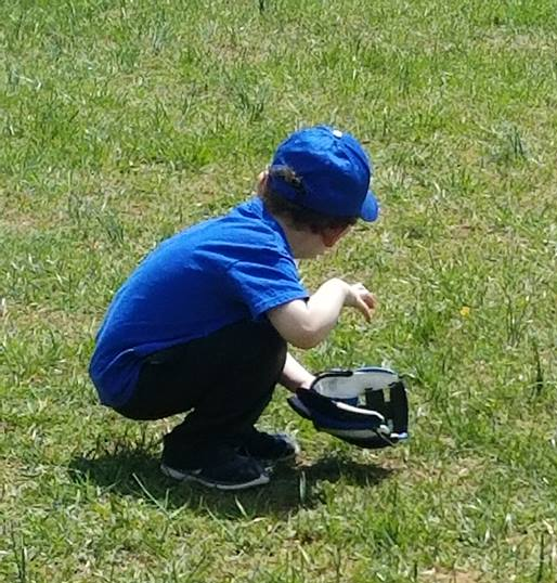 young child crouching with baseball mitt