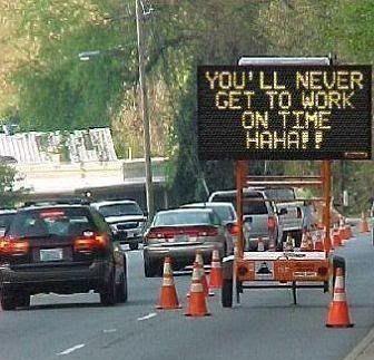 Highway Traffic Billboard reads "You'll never get to work on time! HAHA"