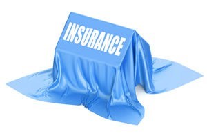 An "insurance blanket" is thrown over a house, simulating force-placed insurance.